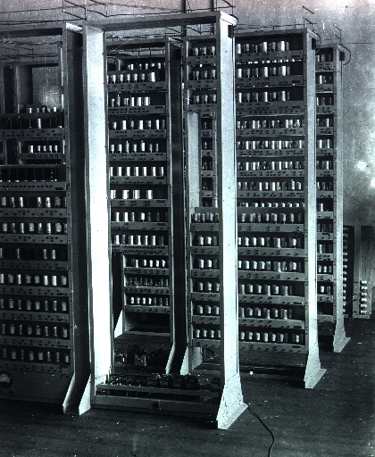 EDSAC under construction at Cambridge: tall racks of valves and wiring