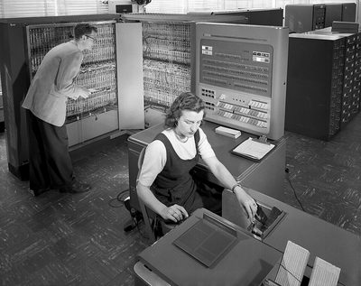 A man and a woman operating an IBM 704 computer at NACA Langley in 1957