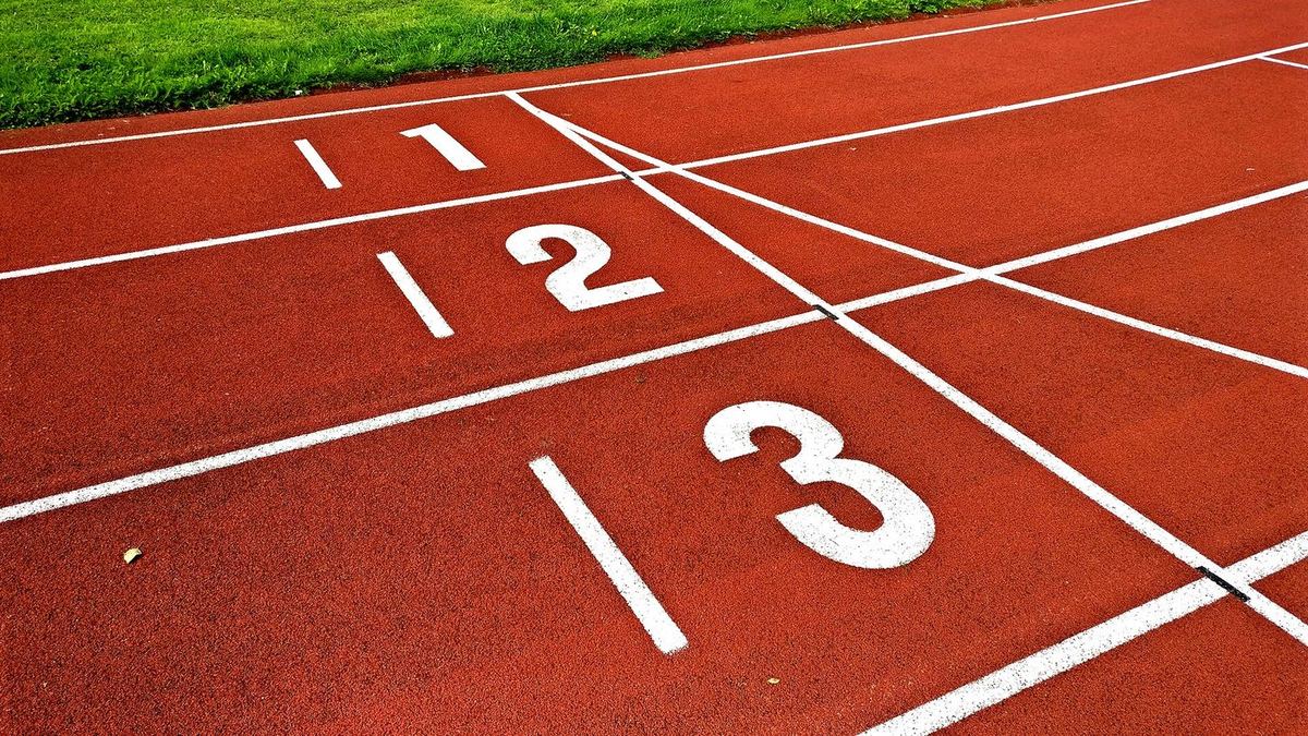 The start of an athletics track with the lane numbers 1, 2 and 3 painted on it