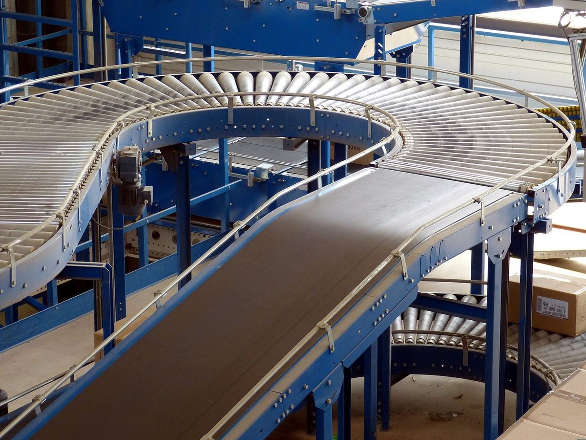 A conveyor belt curving through a factory