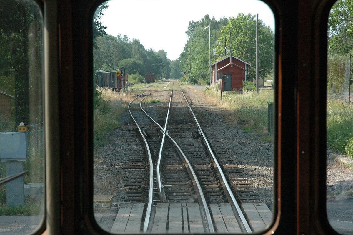 A railway turnout seen from a train: a single track splitting into two