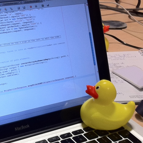 A rubber duck beside a keyboard